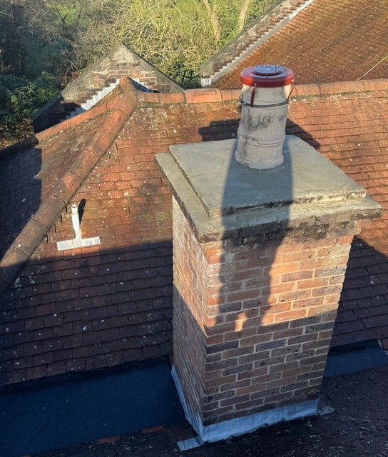 Brick chimney stack repair by professional roofing company in Slough