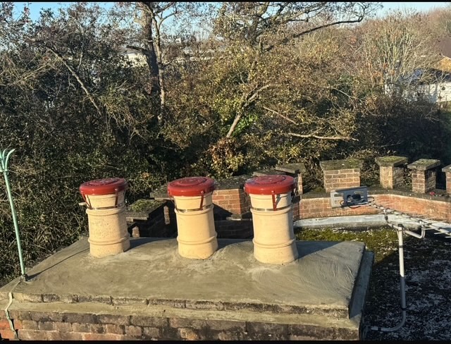 Chimney pots and tiled roof repair by roofing company in Windsor