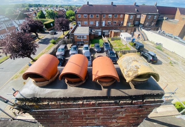 Brick chimney stack maintenance by roofing company Surrey