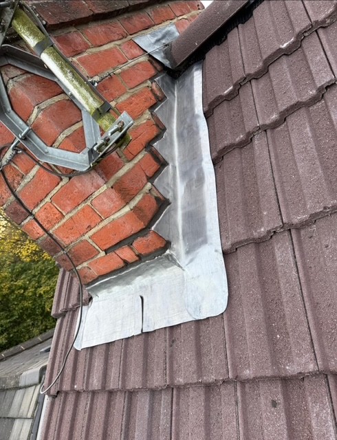 Lead flashing repair around roof tiles by roofing company in Slough
